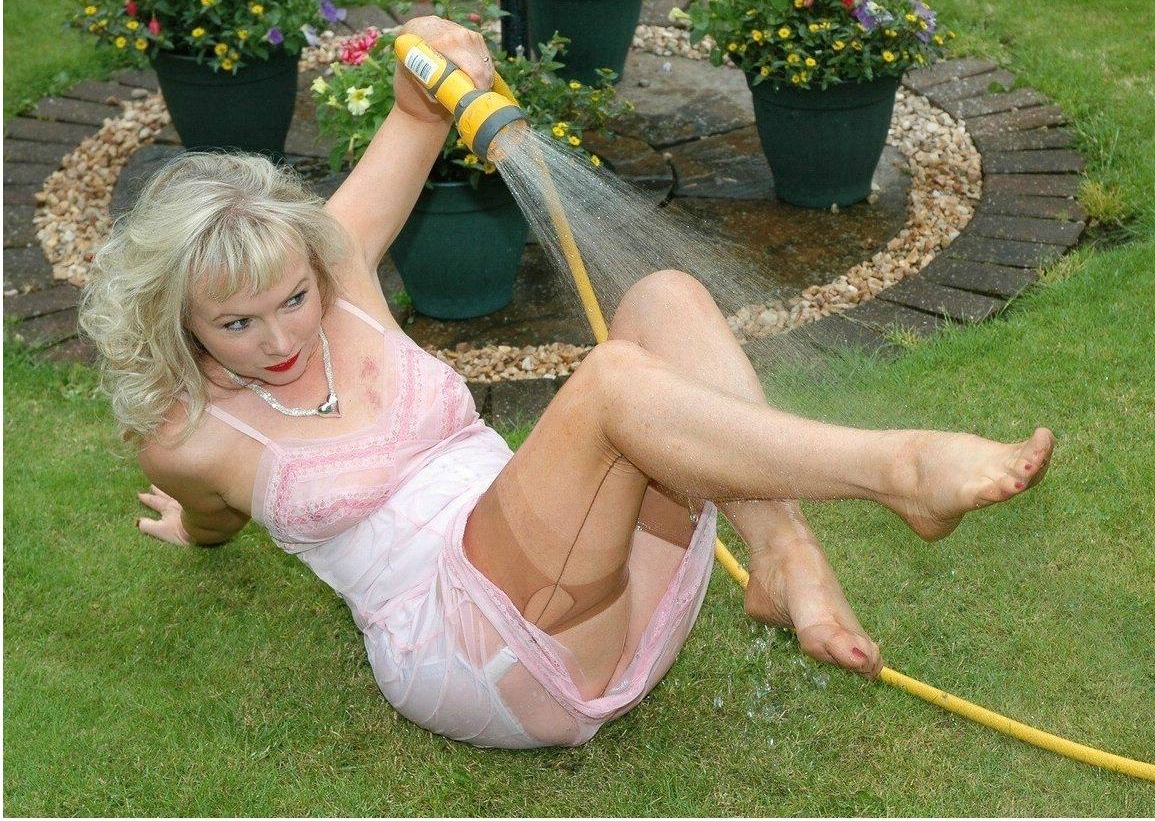 Mature Woman wearing Wet Tan Seamed Stockings and Wet Pink Slip